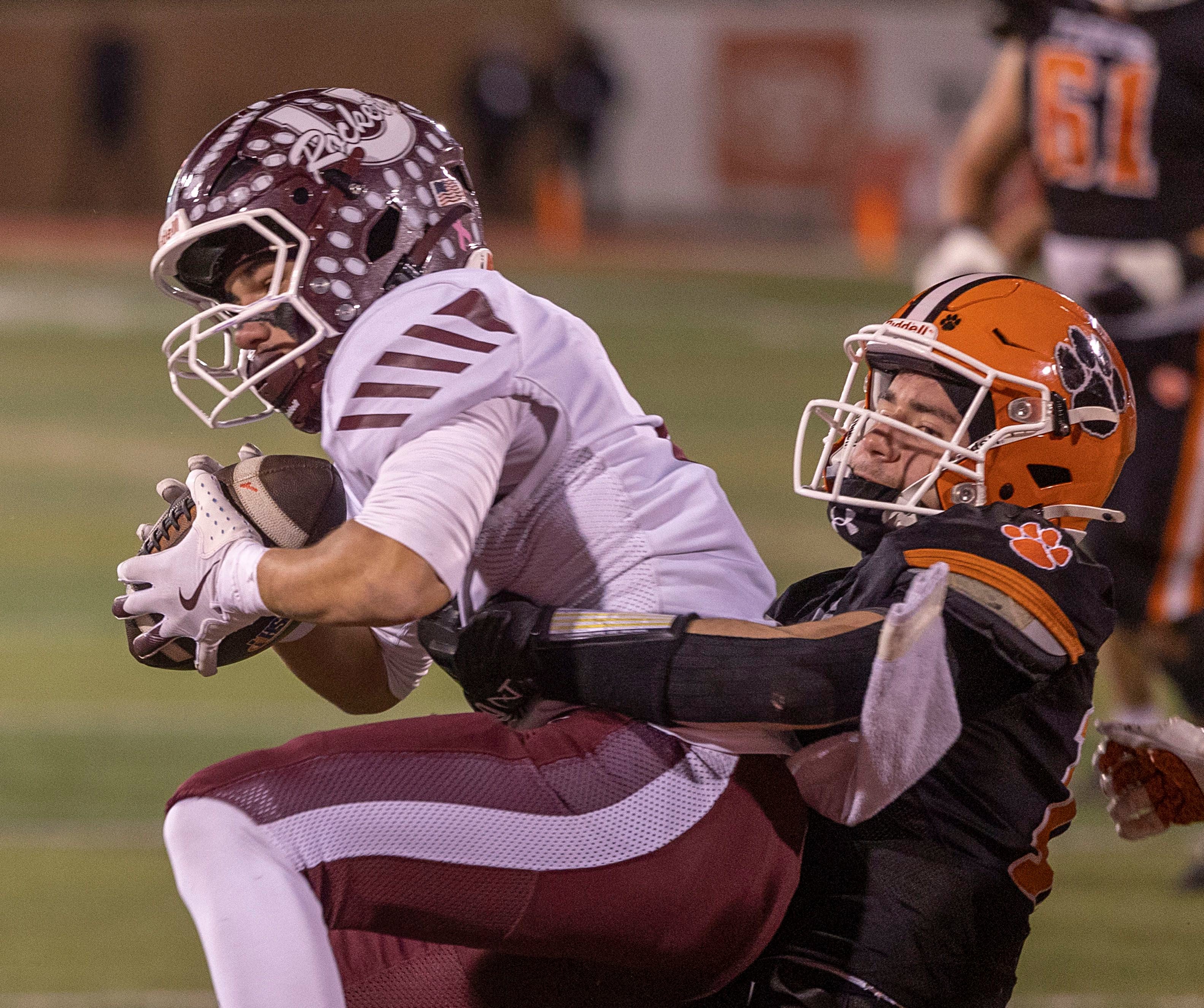 Byron's Andrew Talbert hauls down Tolono-Unity's Tyler Henry Friday, Nov. 28, 2025, in the Class 3A football finals at Hancock Stadium at ISU.