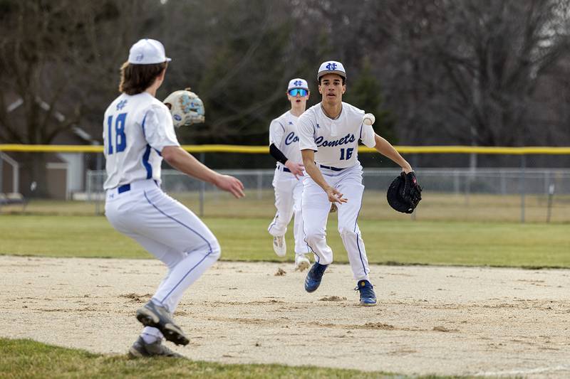 Newman’s Isaiah Williams shovels the ball to Garret Matznick for an out against Sterling Tuesday, March 12, 2024.
