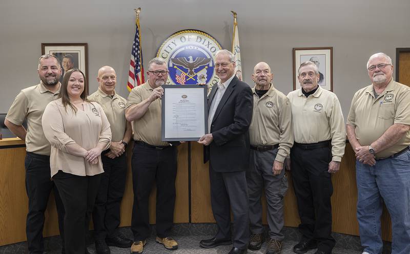 Veterans Memorial Park Commission members gather around Dixon Mayor Glen Hughes on Monday, March 3, 2025, after the city was proclaimed an official POW/MIA city. Signage will be later installed around the city recognizing the distinction. With the designation the city can host POW/MIA ceremonies and fly flags. National POW/MIA Recognition Day is held on the third Friday in September.