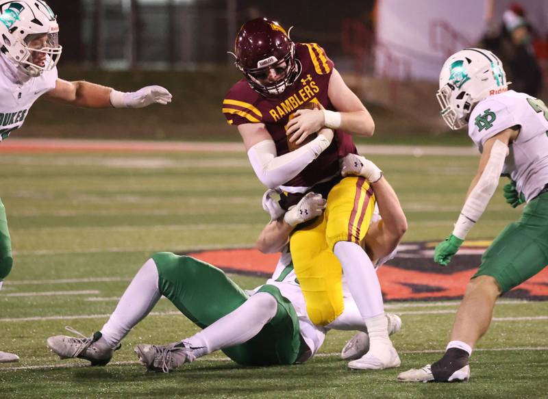 Loyola Academy's Ryan Fitzgerald tries to pull free from a York tackler during their Class 8A state championship game Saturday, Nov. 30, 2024, in Hancock Stadium at Illinois State University in Normal.