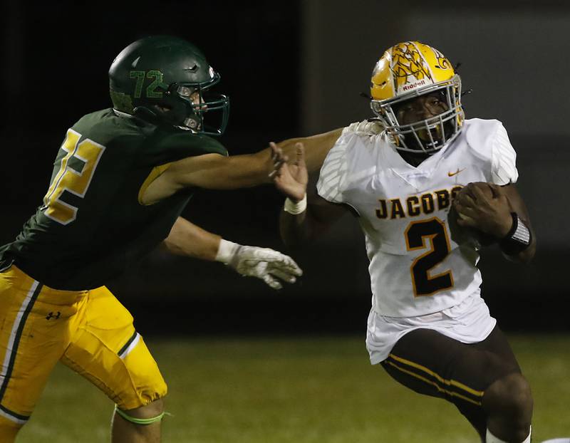 Jacobs’ Antonio Brown, right. runs out of the grasp of Crystal Lake South's  Kyle Skrzypczynski during a Fox Valley Conference football game Friday, Aug. 26, 2022, between Crystal Lake South and Jacobs at Crystal Lake South High School.