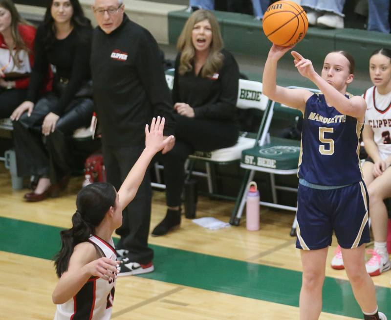Marquette's Chloe Larson lets go of a shot over Amboy/Ohio's Tyrah Vaessen during the Class 1A Regional championship on Thursday, Feb. 20, 2025 at St. Bede Academy.