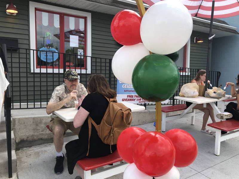 People enjoy ice cream at Rita's Italian Ice's grand opening in McHenry May 4, 2024.