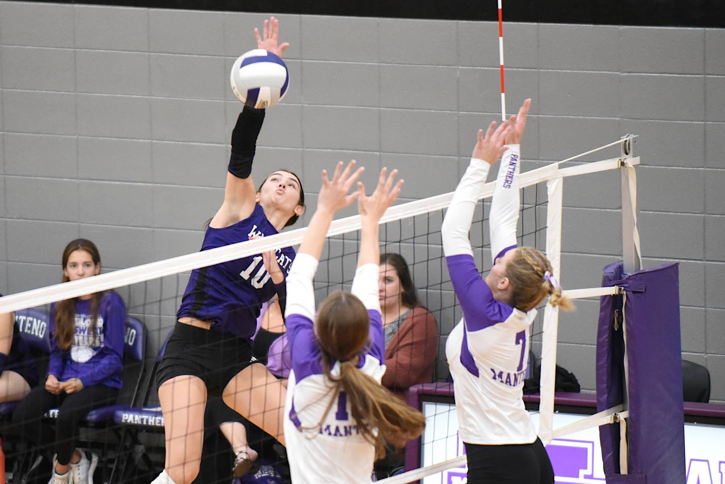 Wilmington's Rachel Smith, left, looks to send a hit past Manteno's Olivia McElroy, center, and Leah Milton during a game at Manteno Tuesday, Oct. 7, 2025.
