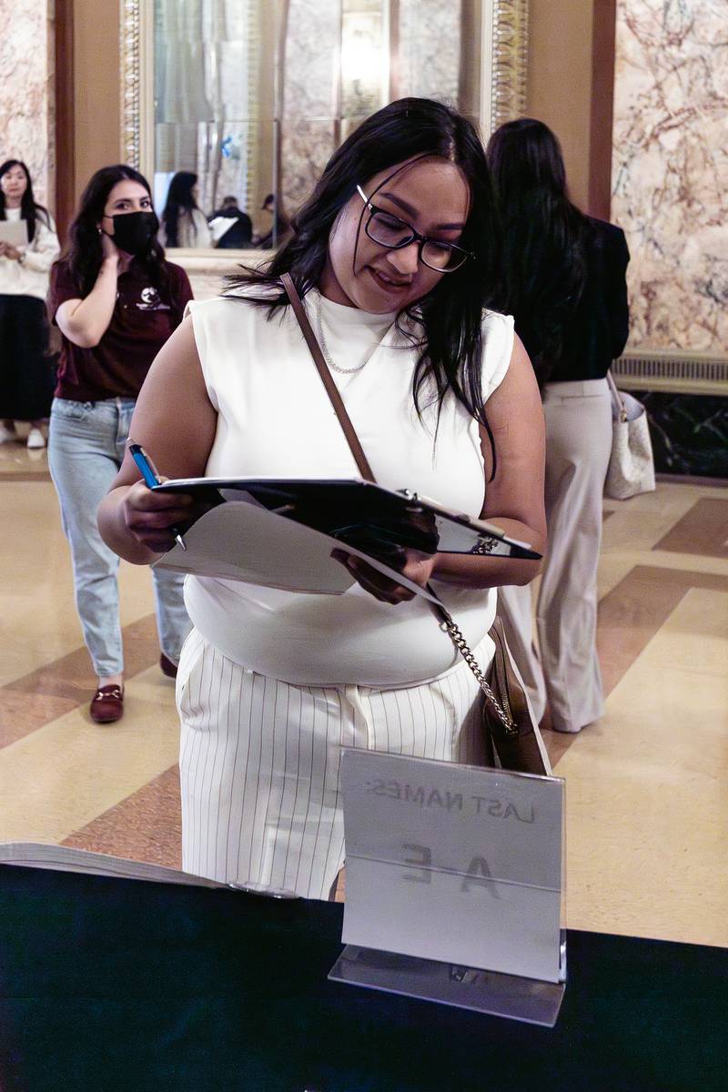 New U.S. citizen, and Joliet resident, Elizabeth Arcos, registers to vote following the Naturalization Ceremony at Rialto Square Theatre in Joliet on April 17, 2025.