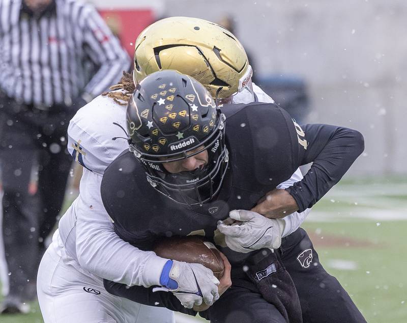 Lena-Winslow's Kasch Lessman is tackled by Althoff Catholic’s Asher Peterson Friday, Nov. 29, 2024, in the class 1A football state final.