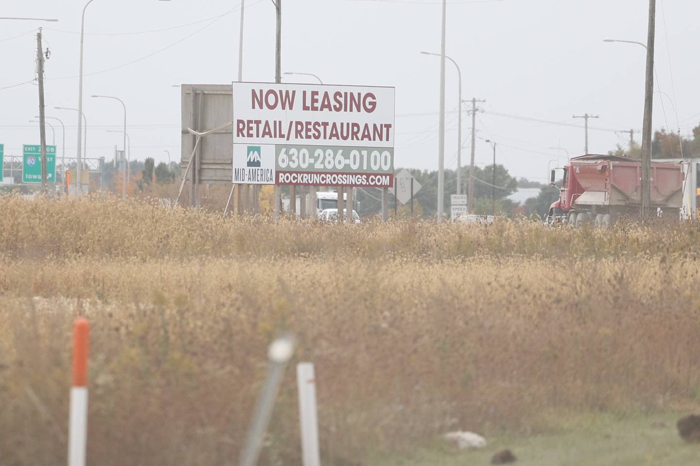 A sign advertising leasing sits along SE I-55 Frontage Road as groundwork continues on the Rock Run Crossings Development near the I-55 and I-80 interchange in Joliet on Tuesday, October 11th.