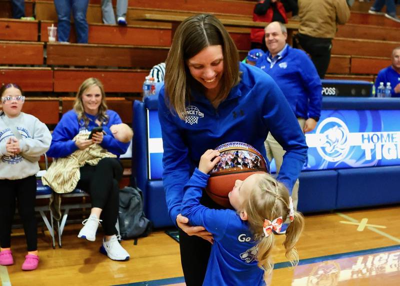 Princeton  coach Tiffany Gonigam celebrates with her daughter, Quimby, after becoming the winningest coach for the PHS girls with Monday's 54-17 win over Henry.