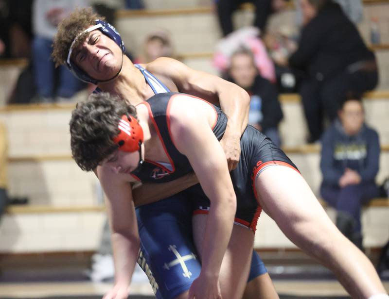 Bradley-Bourbonnias's Lee Shawn wrestles Marquette's Marcus Baker on Wednesday, Jan. 14, 2026 in Bader Gymnasium at Marquette Academy.