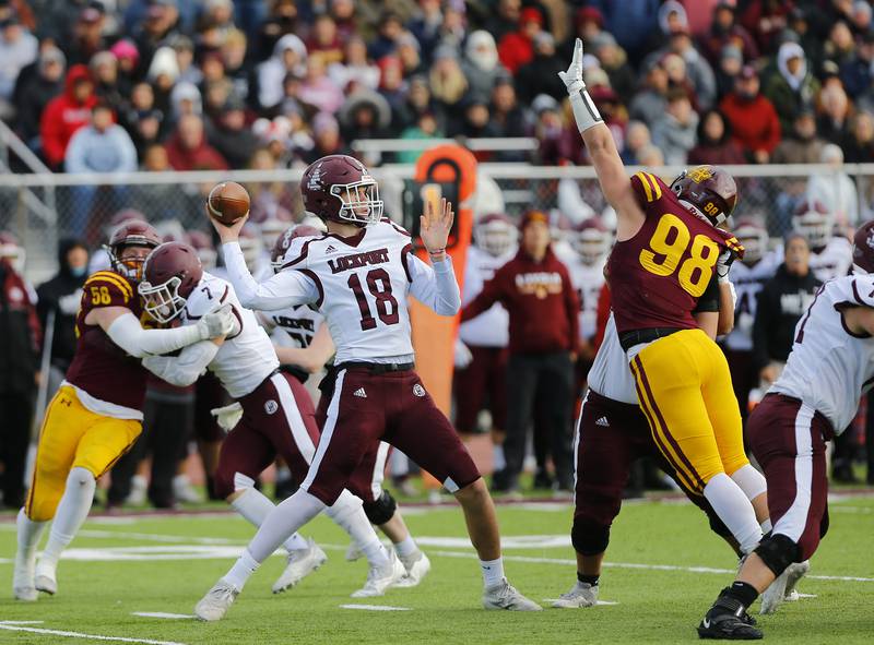 Lockport's Hayden Timosciek passes the ball as Loyola's Graham Mccabe tries to block it during the IHSA Class 8A varsity football semifinal playoff game between Lockport Township and Loyola Academy on Saturday, November 20, 2021 in Wilmette.