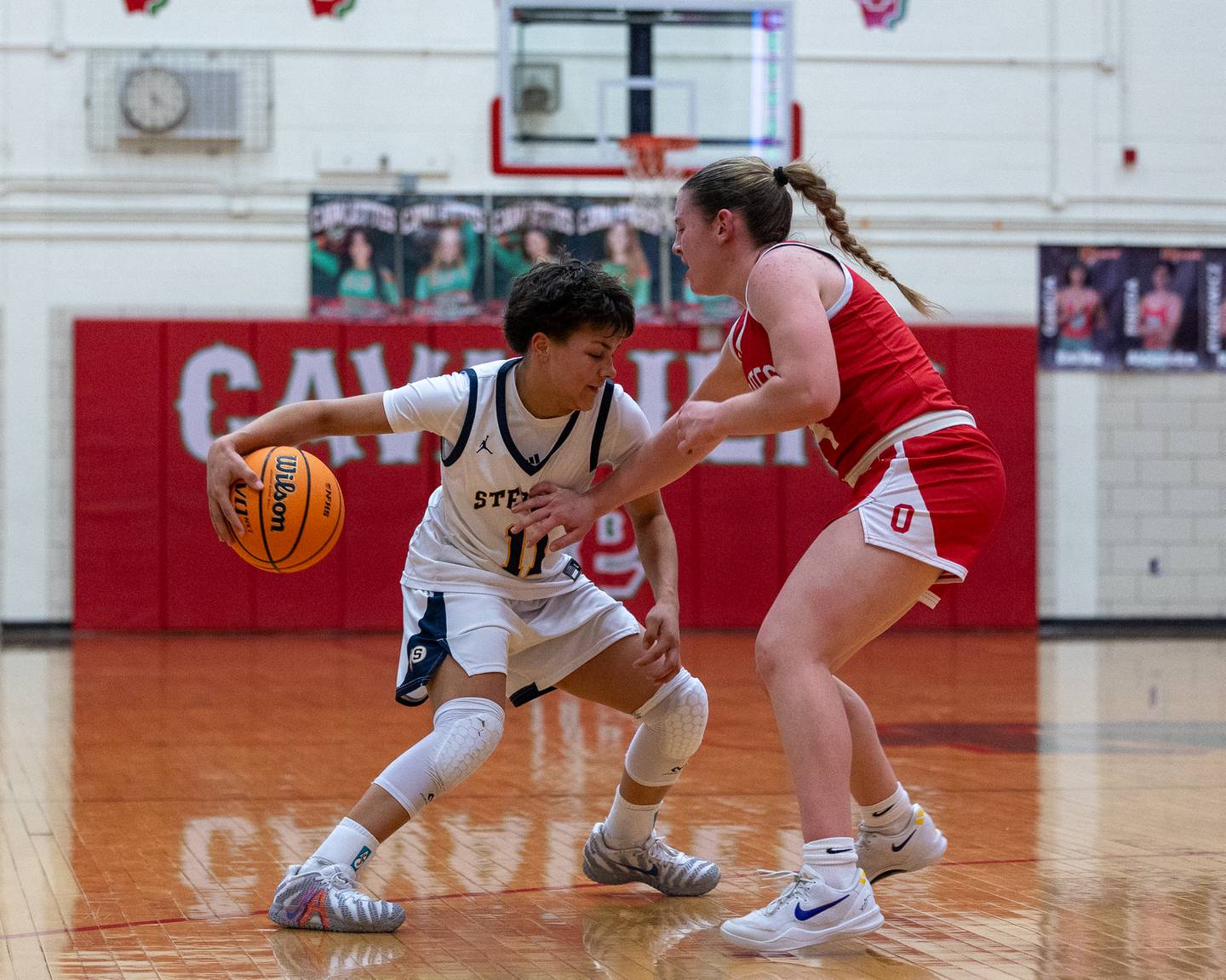 Sterling's Joslynn James (11) dribbles behind her back trying to shake Ottawa defender Kennedy Kane (24) on Thursday, Feb. 19, 2026, in La Salle-Peru's Sellett Gymnasium.
