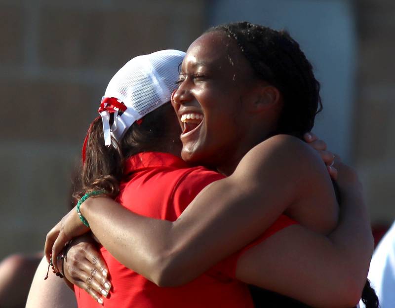 Huntley’s Dominique Johnson is greeted by coach Jennifer Garza after competing in the long  jump in IHSA Class 3A Girls Sectional Track and Field Meet action at Red Raider Stadium on the campus of Huntley High School in Huntley on Wednesday, May 14, 2025.
