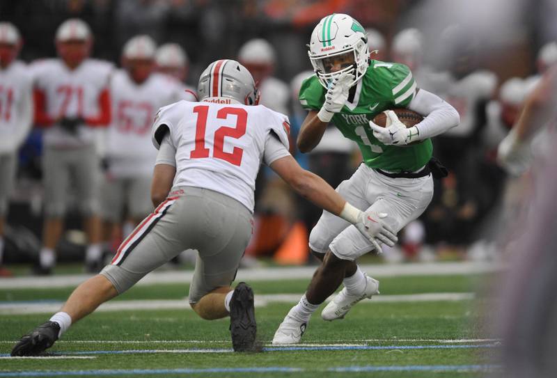 York’s Kelly Watson tries to get past Palatine’s Aiden Wimer in a Class 8A quarterfinal playoff football game in Elmhurst on Saturday, November 12, 2022.