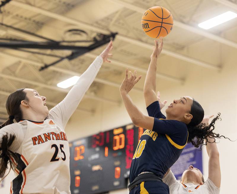 Sterling’s Nia Harris puts up a shot over Washington’s Danielle Guedet Monday, March 3, 2025, during the 3A Supersectional at Rochelle High School.