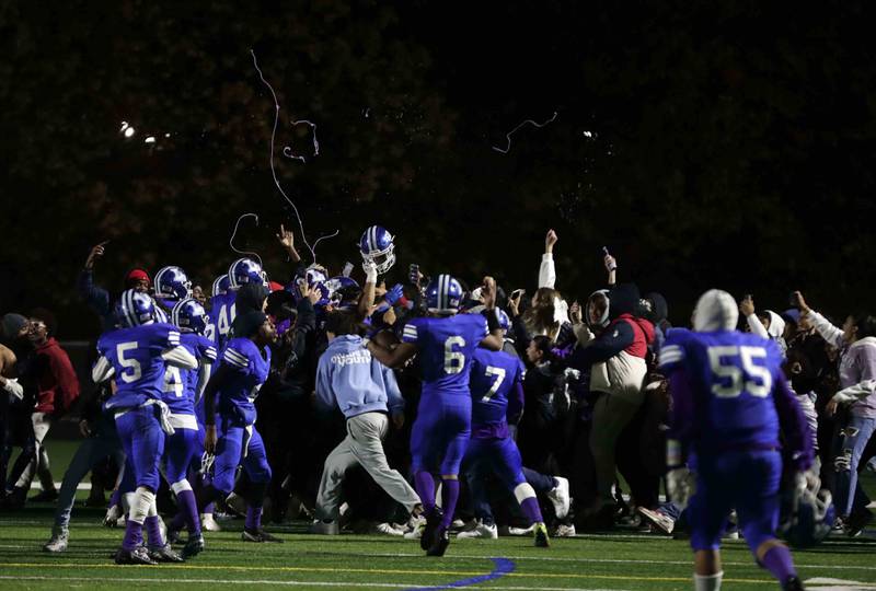 Larkin football players and fans celebrate their win during the annual crosstown rival game at Memorial Field  Friday October 14, 2022 in Elgin.