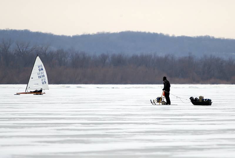 An racing official uses a motorized sled to move around quickly on the ice on Senachwine Lake on Thursday Jan. 27, 2022 near Putnam.