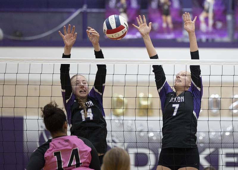 Dixon’s Leah Carlson (left) and Makenzie Toms work to block a shot against Winnebago Tuesday, Oct. 22, 2024, in Dixon.