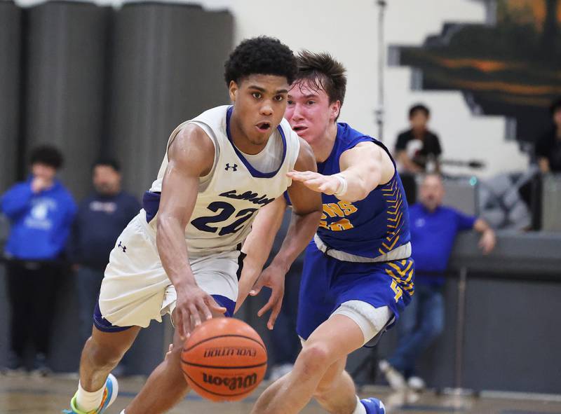 Riverside Brookfield’s Steven Brown (22) rolls past the Lyons defense during a boys varsity basketball game on Friday, Jan. 26, 2024 in Riverside, IL.
