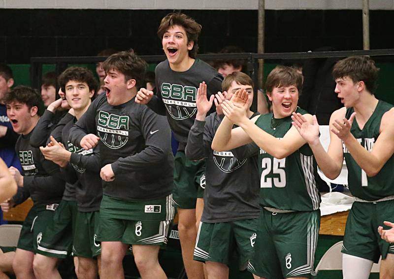 Members of the St. Bede boys basketball team react after getting an upset victory over number one seed Marquette in the Class 1A Regional semifinal on Wednesday, Feb. 22, 2023 at Midland High School.