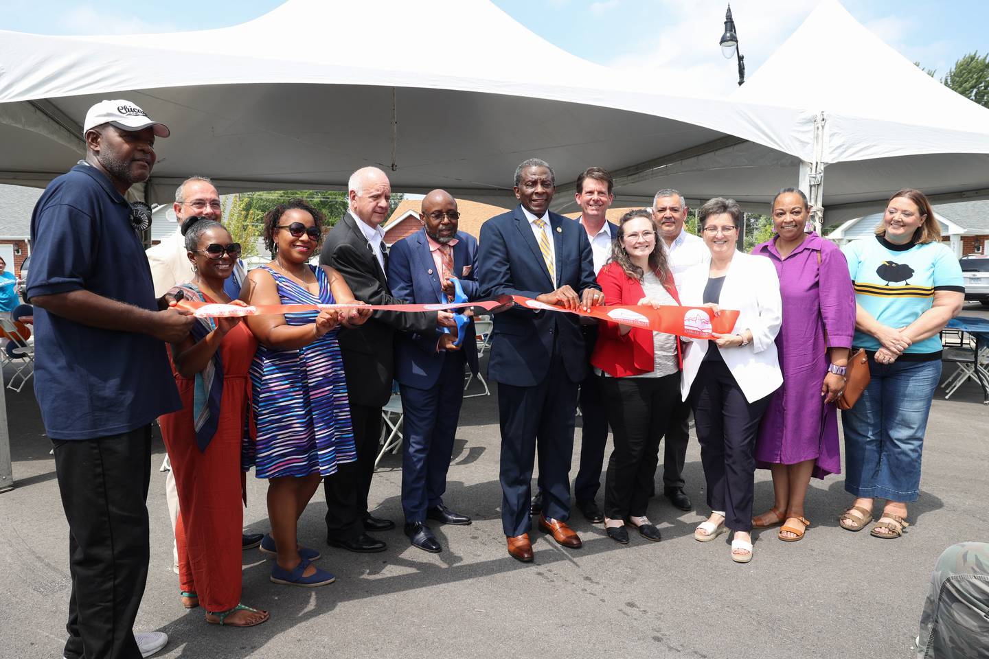 City and local officials stand with Kankakee County Housing Authority board members and staff to officially cut the Kankakee Chamber of Commerce ribbon during the West Harbor Residences ribbon cutting and street dedication ceremony on Wednesday, July 23, 2025.