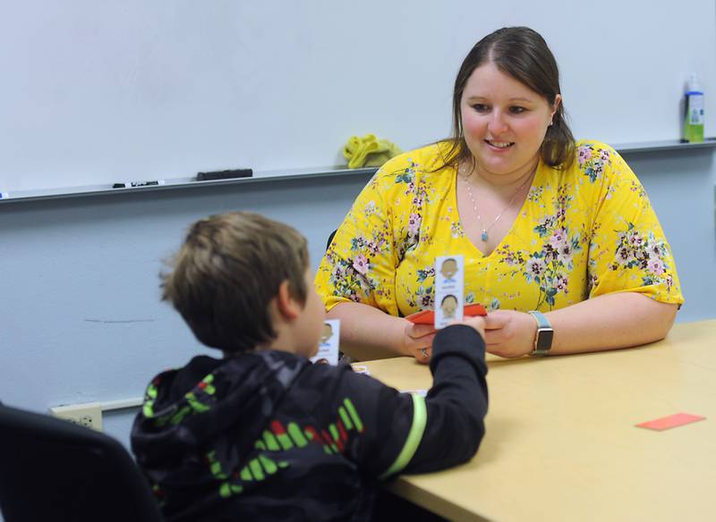 Woodstock School District 200 social worker Kristen Jurca plays a game with Olson Elementary School second-grader Alexander Maldonado,7, Wednesday, April 27, 2022. Jurca is one of the three added social worker positions the school district added this year.