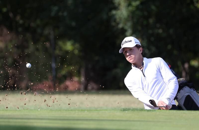 Sycamore’s Andrew Swedberg hits out of the bunker on the par three fourth hole Monday, Sept. 23, 2024, during the Interstate 8 boys golf tournament at the Kishwaukee Country Club in DeKalb.