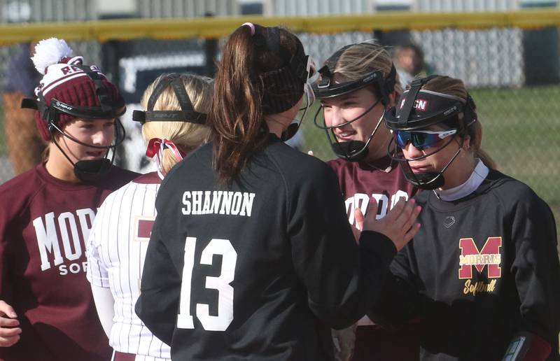 Members of the Morris softball team hi-five each other between innings while playing L-P on Monday, April 7, 2025 at the L-P Athletic Complex in La Salle.
