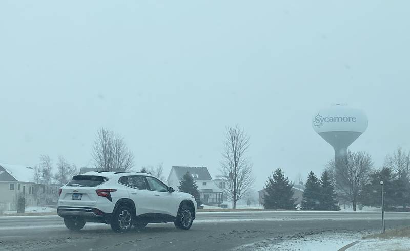 The City of Sycamore water tower looms over Peace Road on a snowy Wednesday, Feb. 12, 2025.