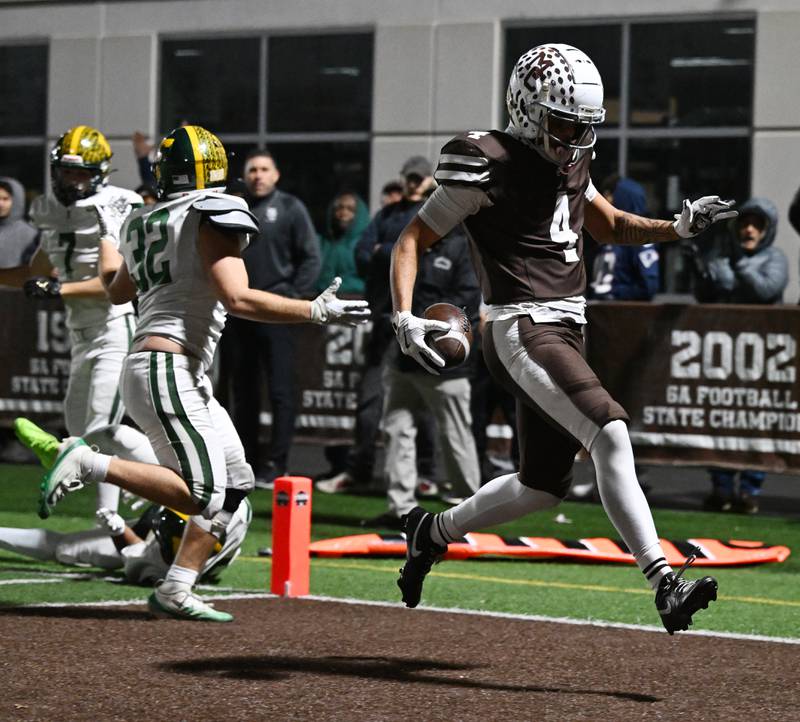 Mount Carmel's Quentin Burrell scores a touchdown during the IHSA Class 8A football semifinal game against Fremd on Saturday, Nov. 22, 2025 in Chicago.