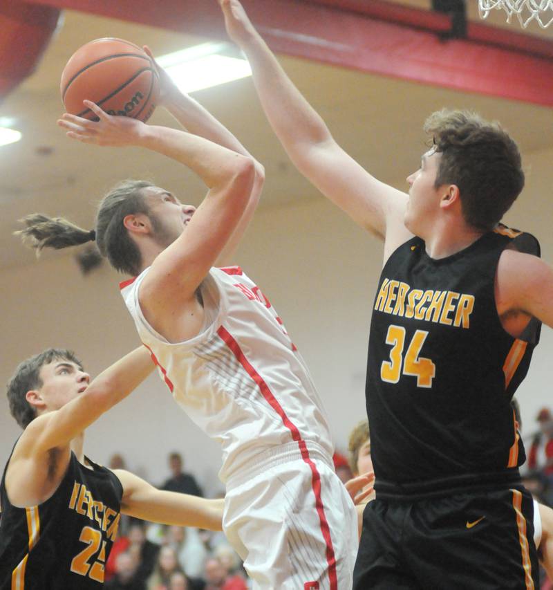 Streator's Quinn Baker shoots past Herscher's Jacob McCree (34) and Tanner Jones (25) on Friday, Dec. 1, 2023, at Streator's Pops Dale Gymnasium.