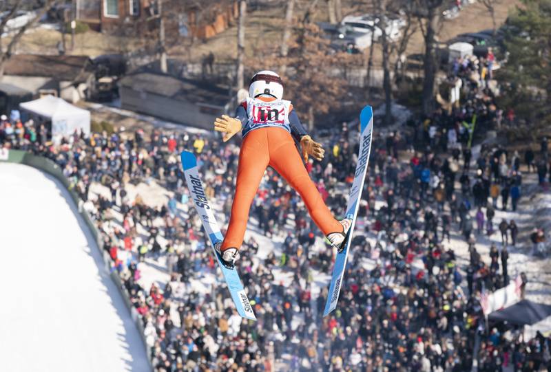 Kalian Erickson-Nichols with the Flying Eagles Ski Club of Eau Claire, Wis., is seen high above the crowd during the Norge Annual Winter Ski Jump Tournament on Sunday, January 26, 2025 at the Norge Ski Jump in Fox River Grove.