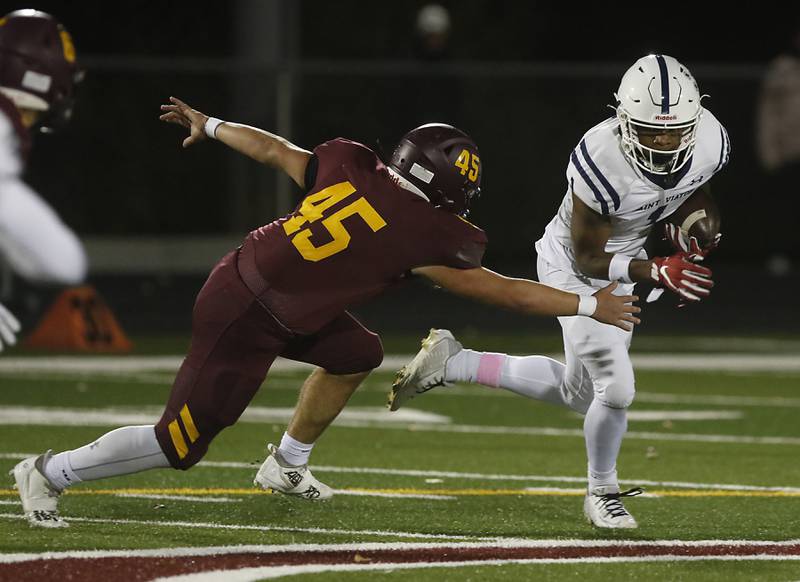 St. Viator's Dayvion Ellis tries to get away from the pursuit of Richmond-Burton's Braxtin Nellessen during a IHSA Class 4A first round playoff football game Friday, Oct. 27, 2023, at Richmond-Burton High School in Richmond.