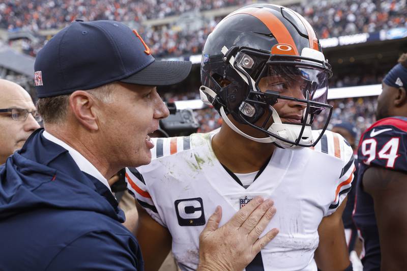 Chicago Bears head coach Matt Eberflus, hugs quarterback Justin Fields after the team's 23-20 win over the Houston Texans, Sunday, Sept. 25, 2022, in Chicago.