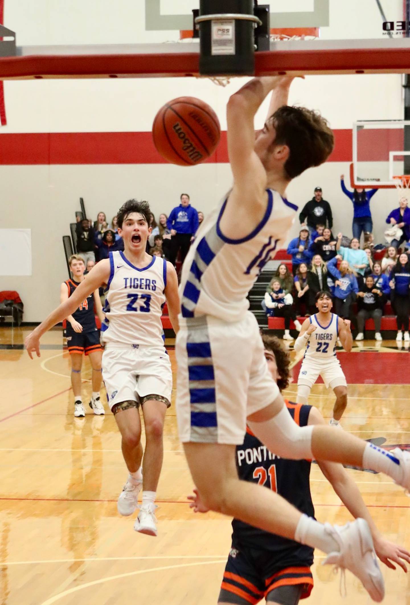 Princeton's Noah LaPorte (23) and Christian Rosario (22) react to teammate Grady Thompson's game-clinching dunk to win Saturday's Colmone Classic championship over Pontiac.