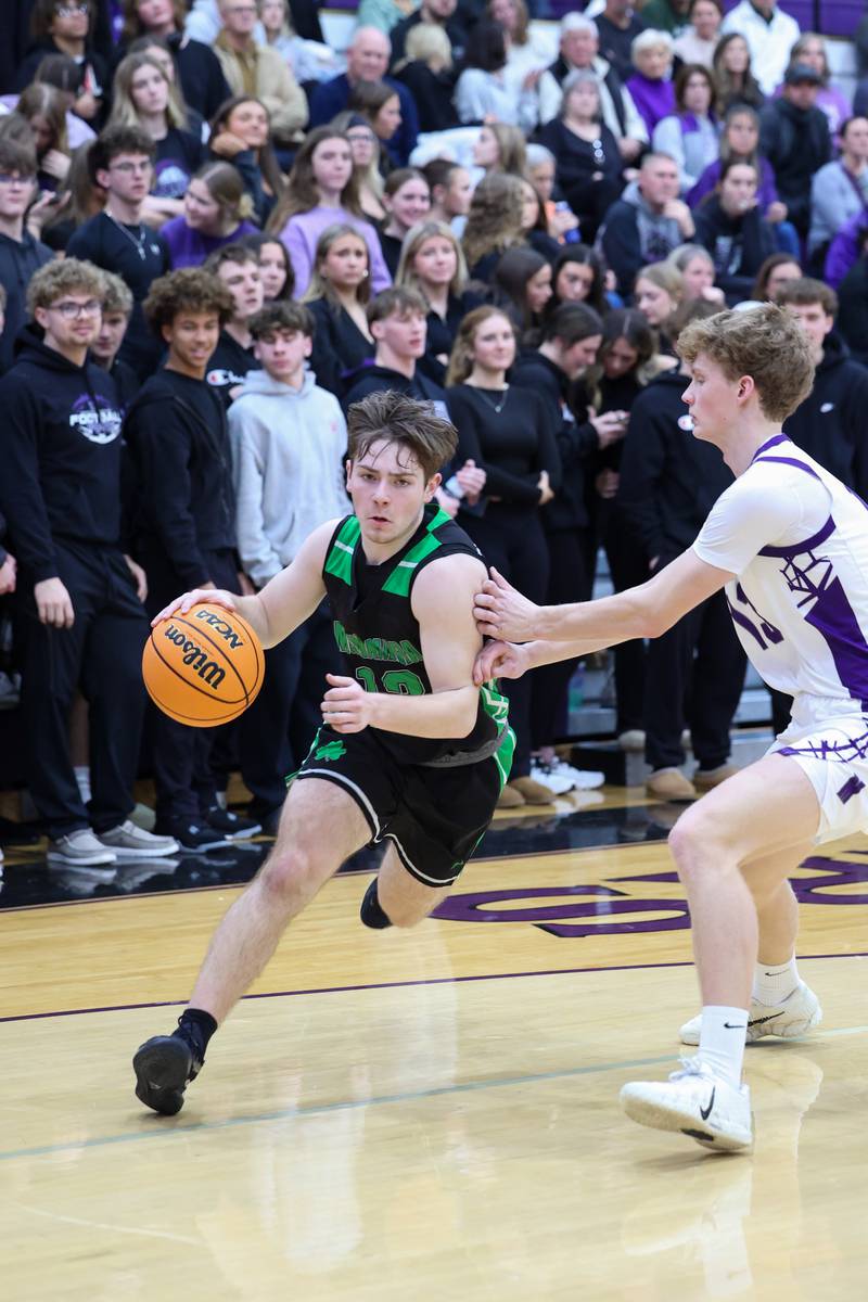 Bishop McNamara's Teddy Fogel drives toward the lane against Manteno's Ramsey Owens during the Fightin' Irish's 61-24 victory over Manteno on Tuesday, Jan. 13, 2026.