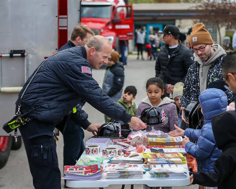 LT. Brian Cramer with the La Grange fire department hands out fire hats at the La Grange Touch a Truck event. April 22, 2023.