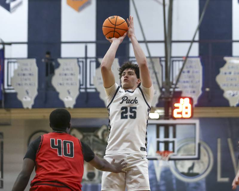 Oswego East's Marc Sanchez-Giron (25) shoots a jumper during their basketball game between Bolingbrook at Oswego East Friday, Jan 30, 2026 in Oswego.