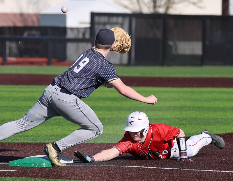 Hiawatha's Mason Alm has to dive across South Beloit's Jaycee Schober to catch the throw on a pickoff attept Thursday, April 16, 2026, during their game at Northern Illinois University in DeKalb.