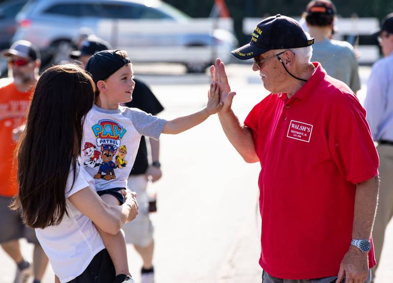 Cash Magill, 3, high-fives Don Olson, right,  during the Moose Cruise Night at the Moose Lodge  in Downers Grove on Friday, June 3, 2023.