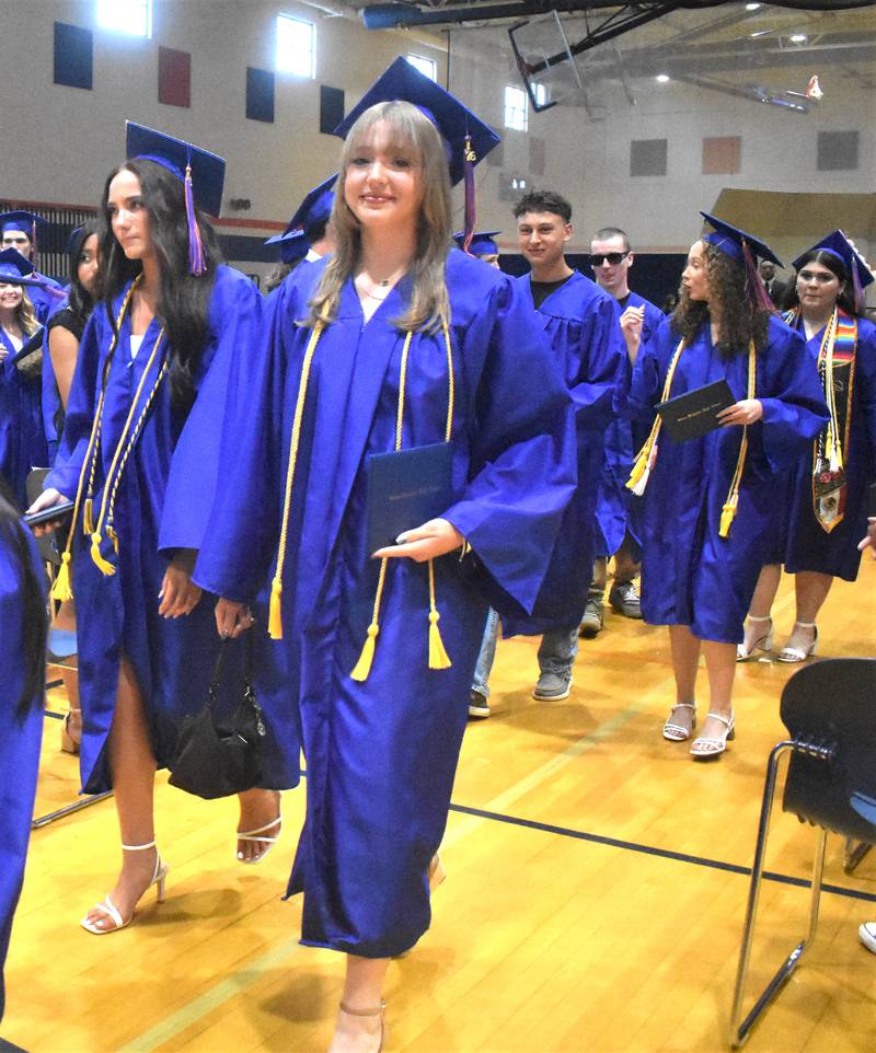 Genoa-Kingston’s Zoey Peterson shows off her diplomas for the crowd Sunday, May 17, 2026, during the commencment ceremony at Genoa-Kingston High School.