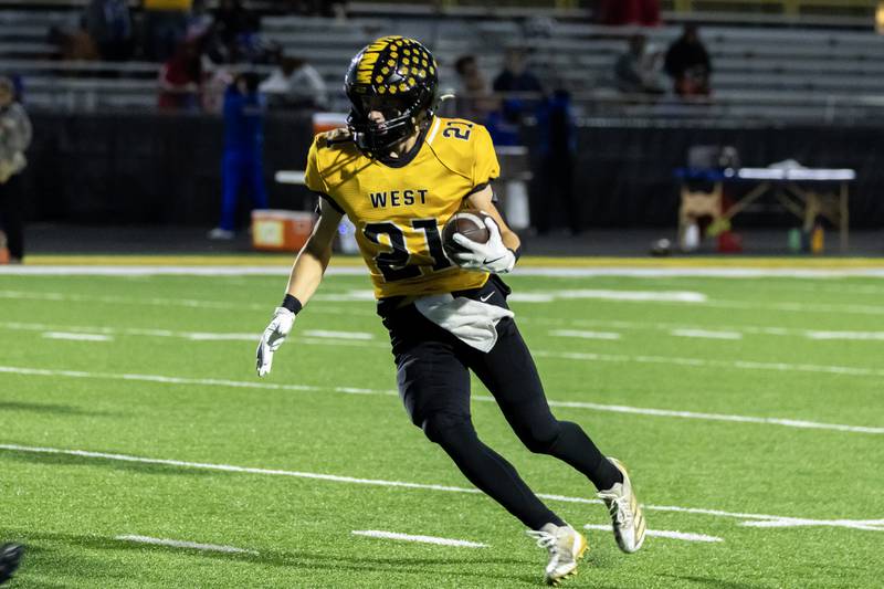 Joliet West's Tyler Bishop looks for an opening during a varsity football game against Joliet Central at Joliet West on Oct. 24, 2025.