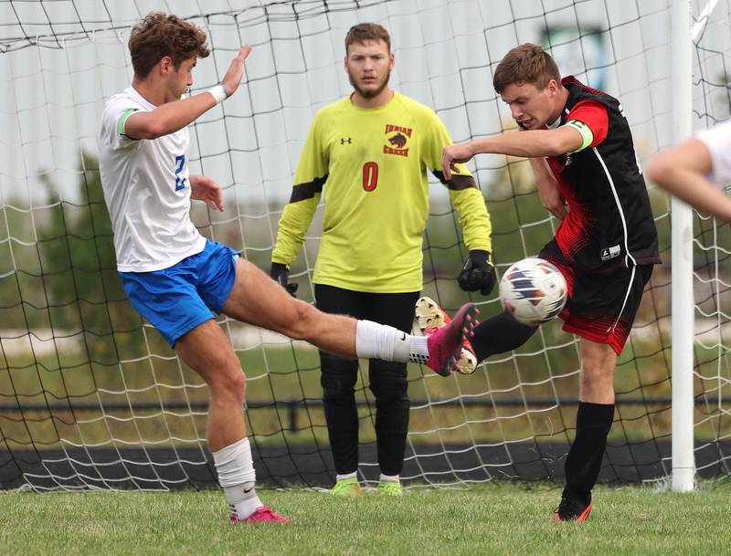 Hinckley-Big Rock's Tyler Smith (left) and Indian Creek's Lucas Odle kick the ball at the same time during their game Wednesday, Sept. 20, 2023, at Pack Park in Waterman.