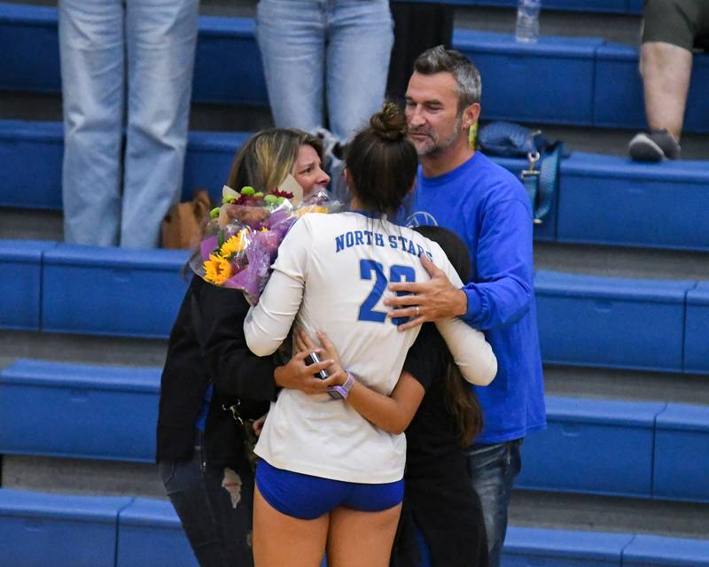 St. Charles North's Haley Burgdorf (23) receives a hug from her family after Haley made her 1,000 career kill during the game on Wednesday Oct. 2, 2024, while traveling to take on St. Francis High School in Wheaton.