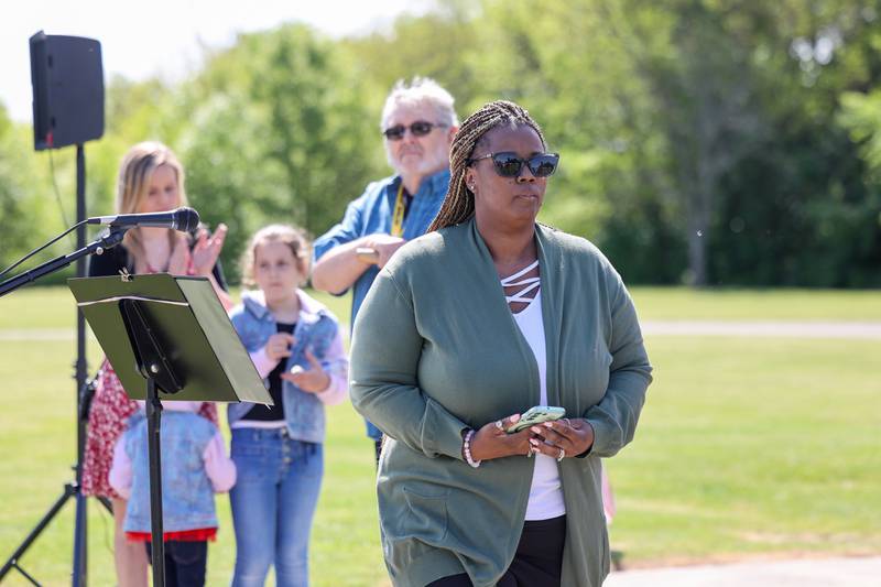 Gilman Healthcare Center employee Theresa Woodle departs from the podium after sharing some words about the late John Kirnbauer, a veteran whose ashes went unclaimed for five years, during a ceremony in his honor on Monday, May 26, 2025, at Kankakee Memorial Gardens.