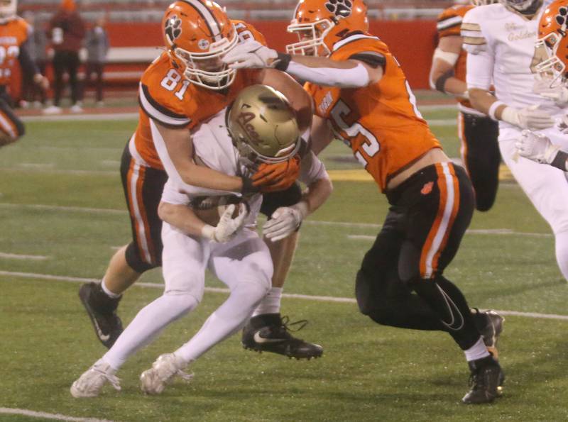 Byron's Braylon Kilduff and teammate Everett Wichman bring down Mt. Carmel quarterback Blayne Sisson during the Class 3A State football championship on Friday, Nov, 24, 2023 at Hancock Stadium in Normal.