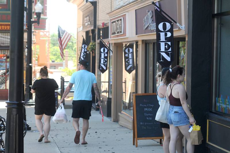 People shop Thursday, June 16, 2022, on the historic Woodstock Square. Construction on Dean Street and the new roundabout at the intersection of South Street, Madison Street and Lake Avenue has created some issues for some local businesses. A few businesses, particularly on the Square, are worried about the effect the work will have on their business this year and next year.
