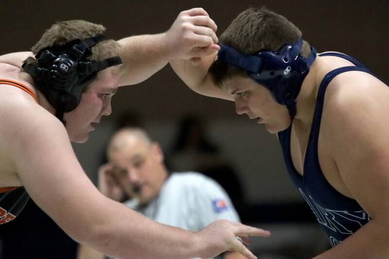 Crystal Lake Central’s Logan Gough, left, battles Cary-Grove’s Lucas Burton  at 285 pounds in varsity wrestling Thursday, Dec. 19, 2024 at Cary-Grove High School in Cary.