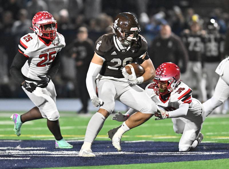Joliet Catholic's Nate Magrini (28) eludes a defender during the IHSA Class 5A first round playoff game against Jacksonville on Saturday, Nov 02, 2024 at Joliet. (Dean Reid for Shaw Local News)