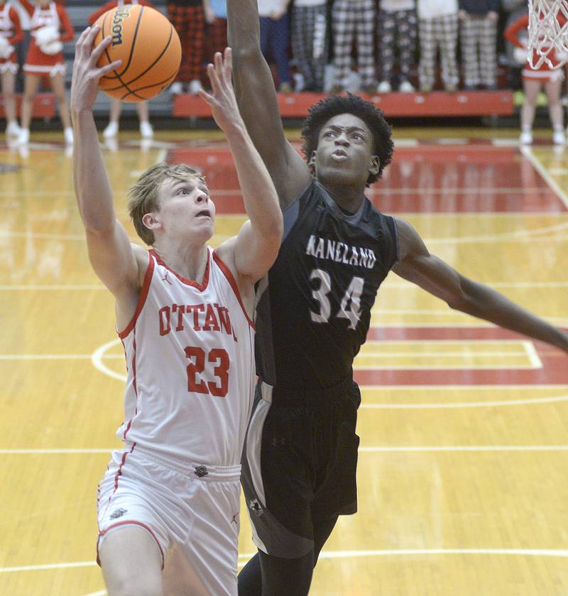 Kaneland’s Jeffrey Hansen works to block this shot by Ottawa’s Owen Sanders in the 1st period Friday at Ottawa.