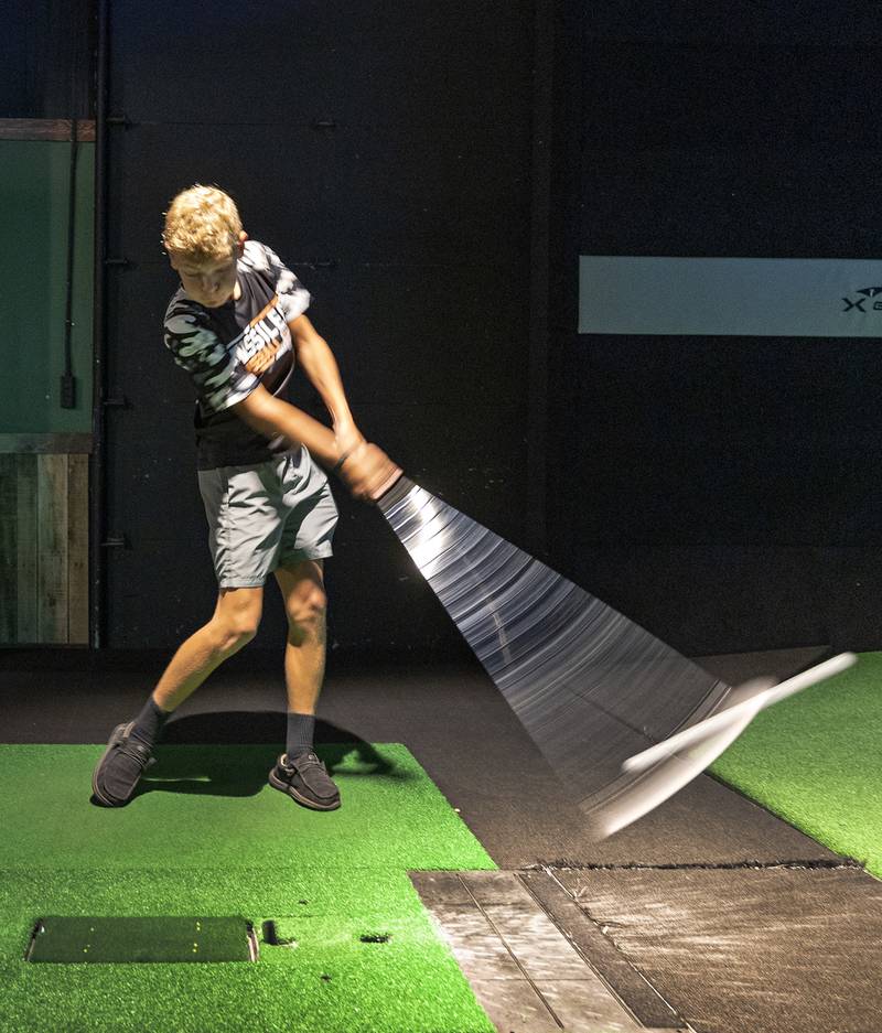 Landen Rogers, 14, of Milledgeville connects with a swing at X-Golf Sauk Valley Thursday, August 7, 2025. The indoor golf simulator is a popular alternative for all levels of golfing skills.